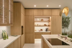 INKO Cocinas diseña cocinas de madera premium con isla de mármol, iluminación integrada y estanterías, estilo contemporáneo.