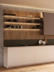 Cocina moderna con estanterías de madera, iluminación LED, encimera oscura y toques premium en muebles blancos. INKO Cocinas