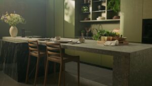 INKO Cocinas, isla de cocina en piedra gris con taburetes de madera, estanterías con platos y plantas; diseño premium en Málaga.